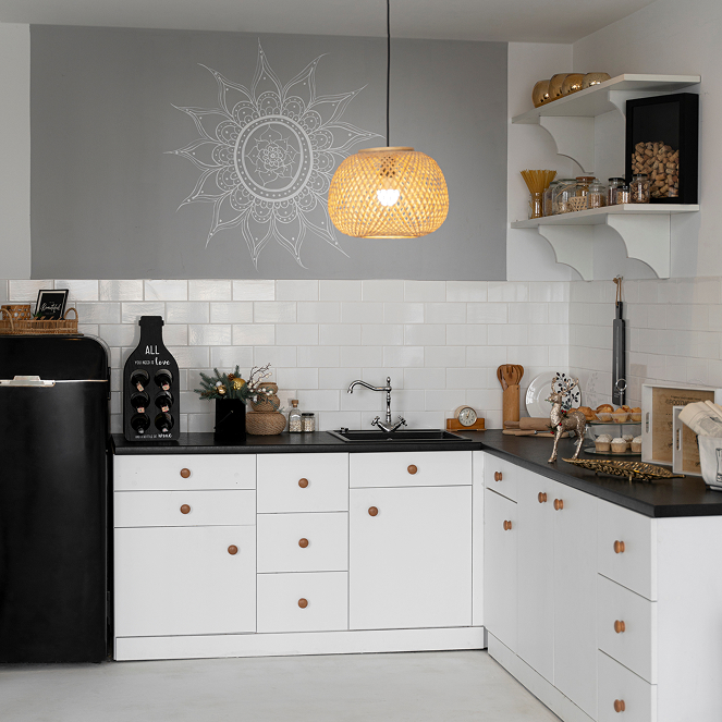 Modern kitchen remodel in Las Vegas with white cabinets, black countertop, and minimalist open shelving